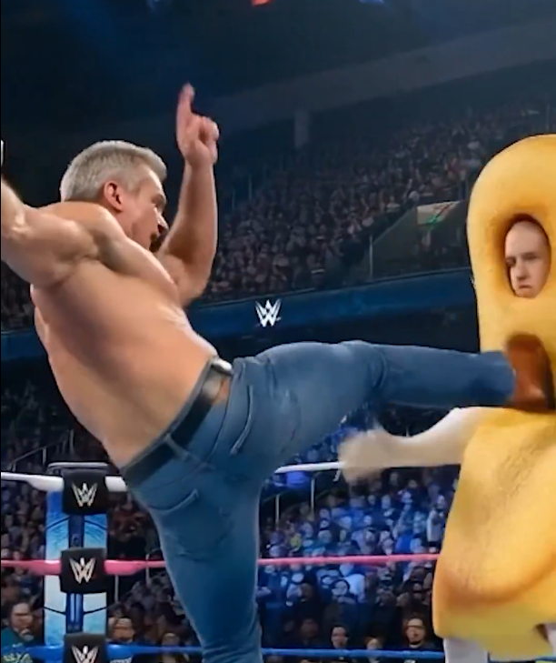 RFK as a wrestler kicking a man dressed up as a twinkie.